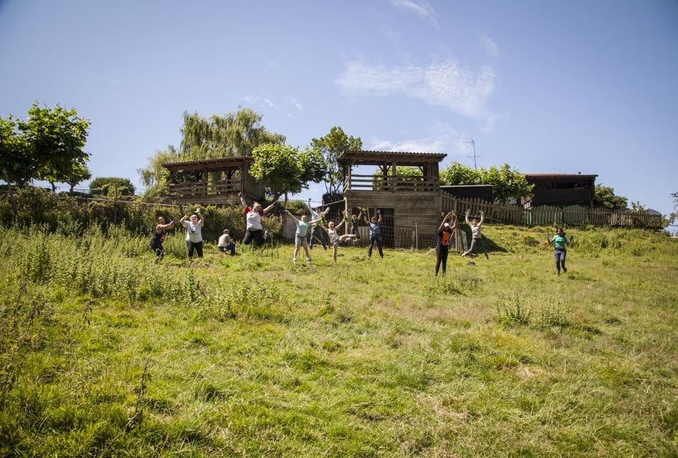 In a momentary pause from pulling the ever-invasive mint, the Semester at Sea group jumps for animal loving joy. 