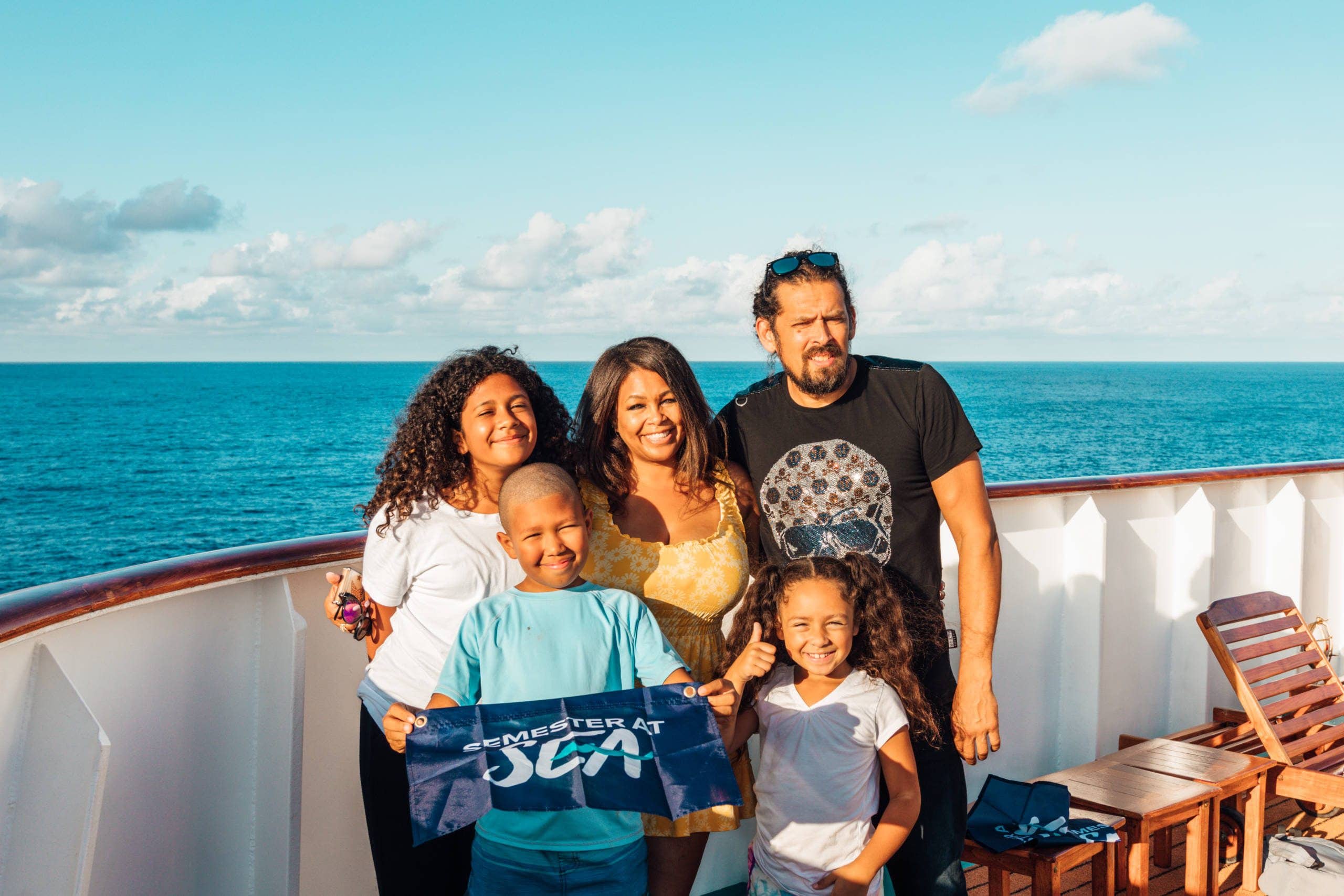 Flores family poses at sunset aboard the MV World Odyssey